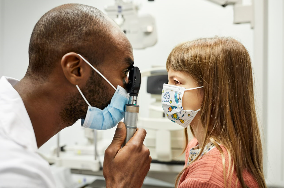 Doctor examining child's eyes