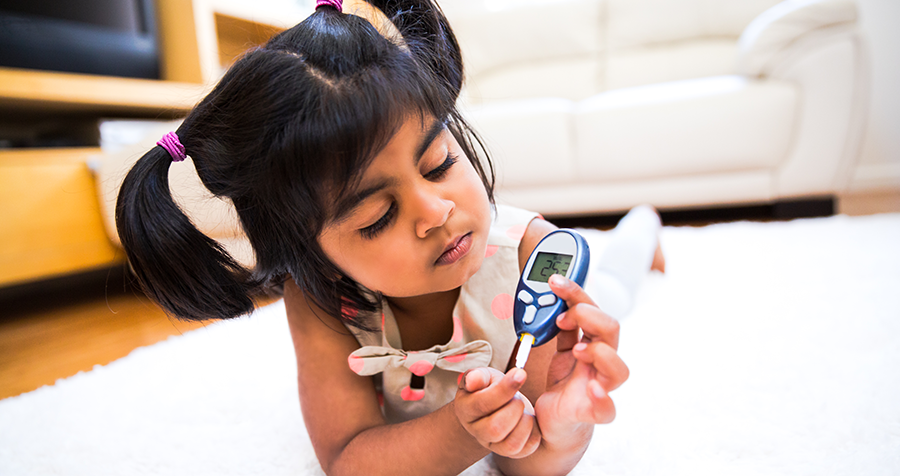 Young girl testing her blood sugar