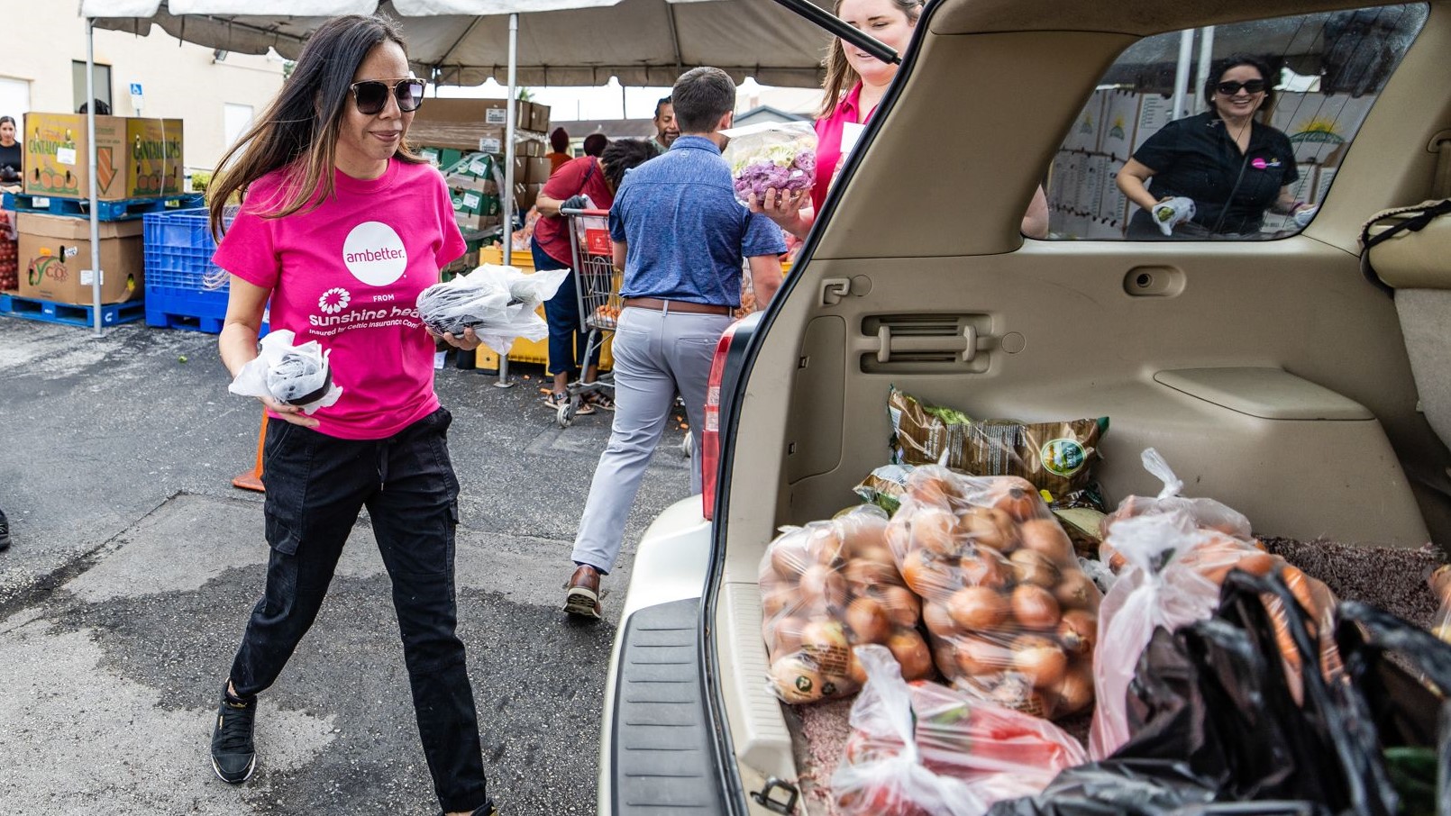 Ambetter team members load food into vehicles during the event. 